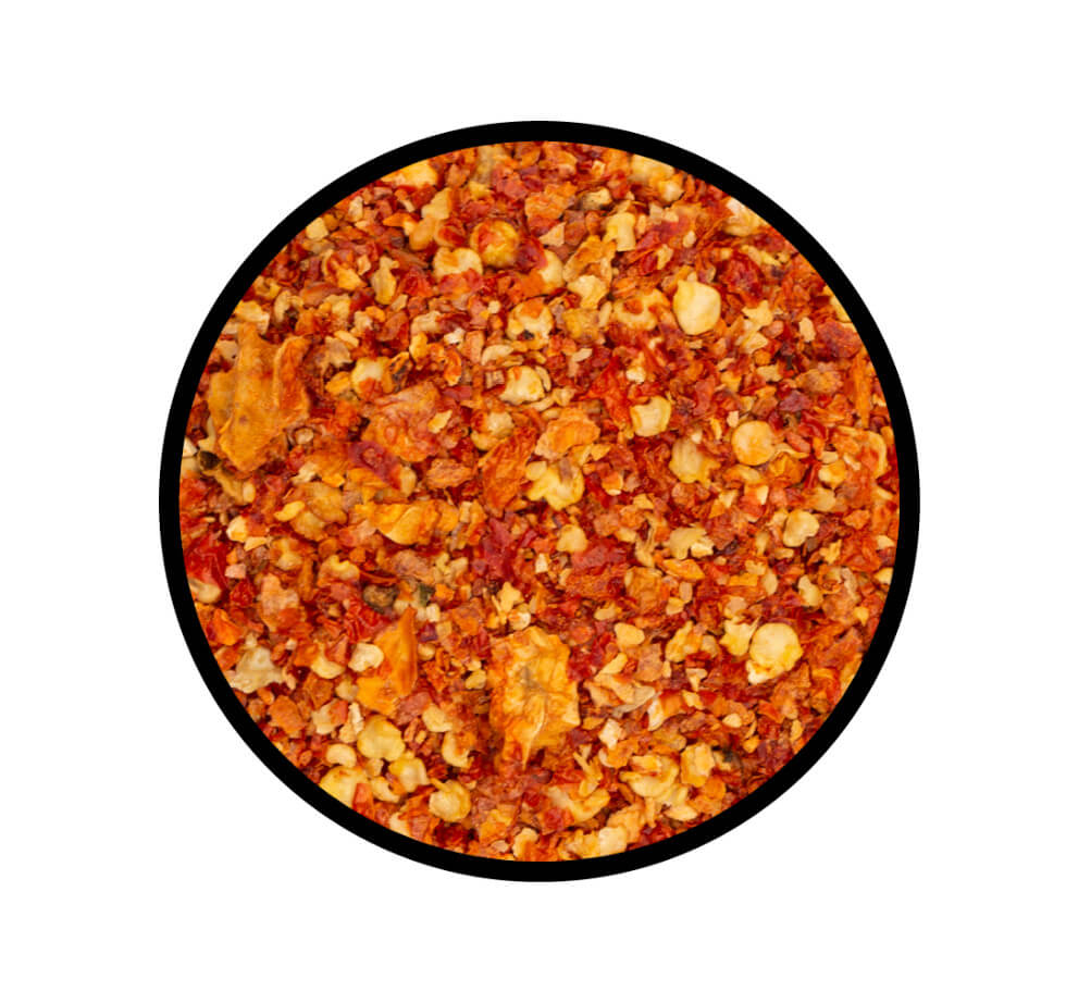 Carolina Reaper Chili geschrotet - Detaillierte Nahaufnahme der Textur / Struktur