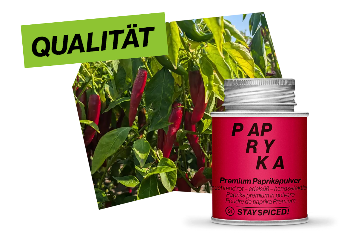 Eine rote Gastro-Dose mit Premium-Paprikapulver, platziert vor frischen Paprikapflanzen als Zeichen höchster Rohstoff-Qualität